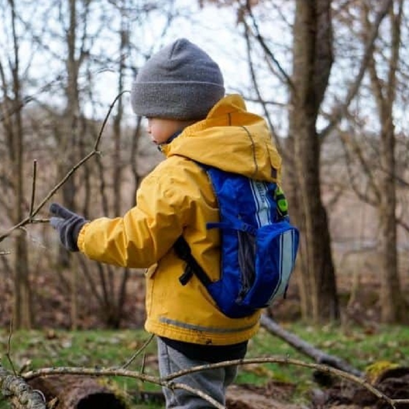 little boy in small backpack